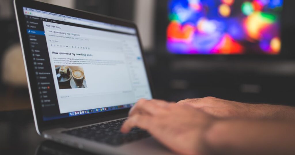 WordPress vs Wix vs Squarespace: writing a blog post on a laptop
