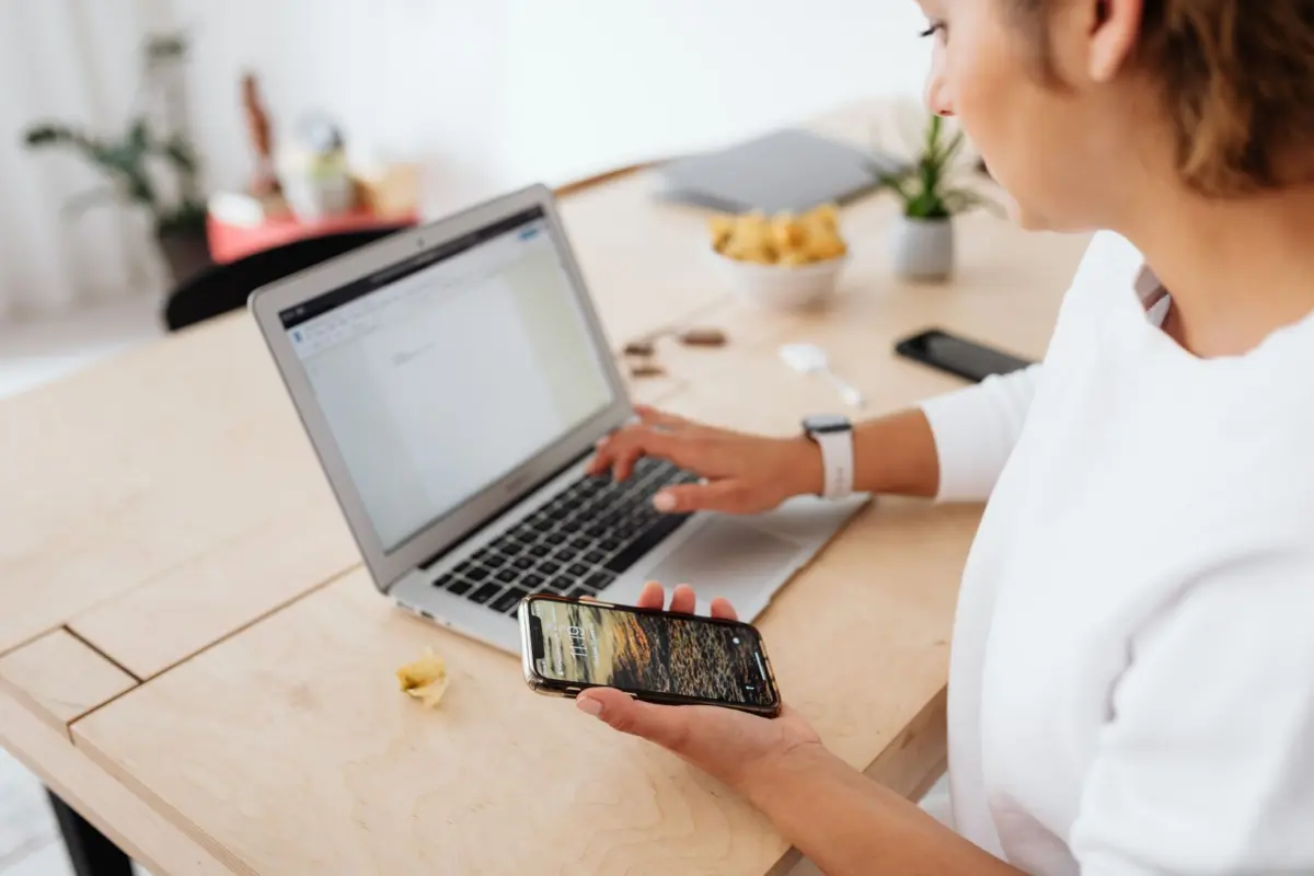 Small business owner checking missing Google reviews on a laptop and smartphone