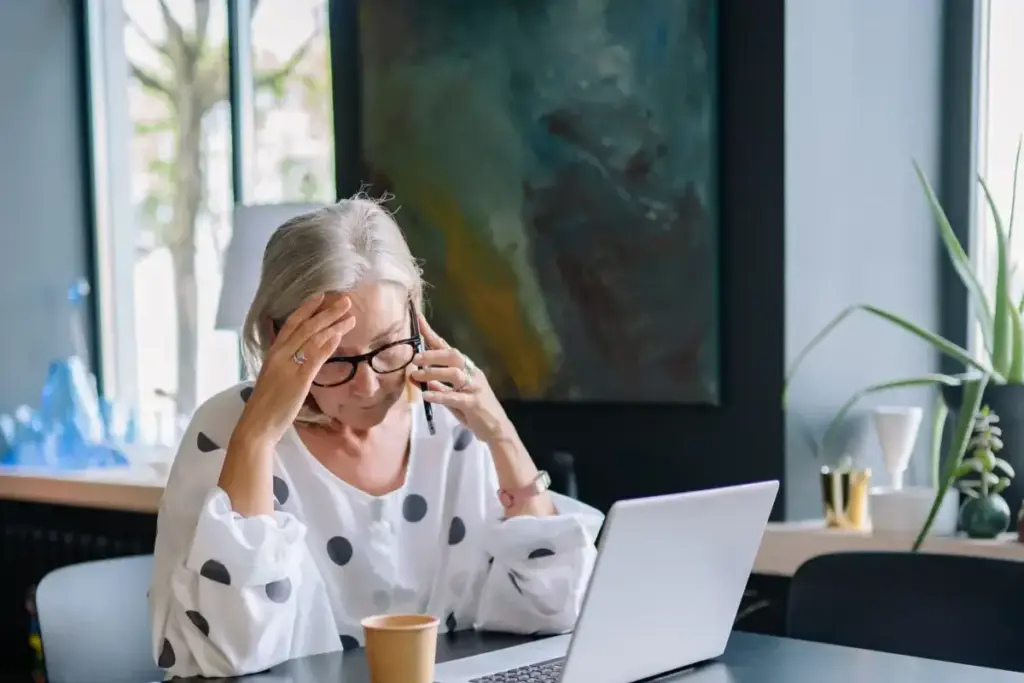 Business owner stressed at her laptop working out how to remove Google reviews from my business