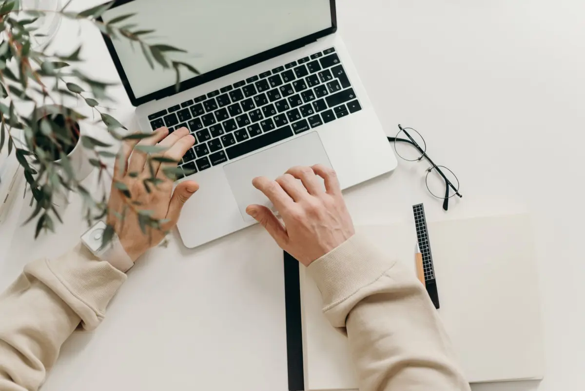 Hands typing on a laptop while checking a website is open to ChatGPT search crawlers