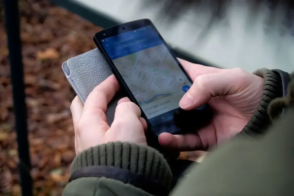 Person using the Google Maps app on a phone to find a local business