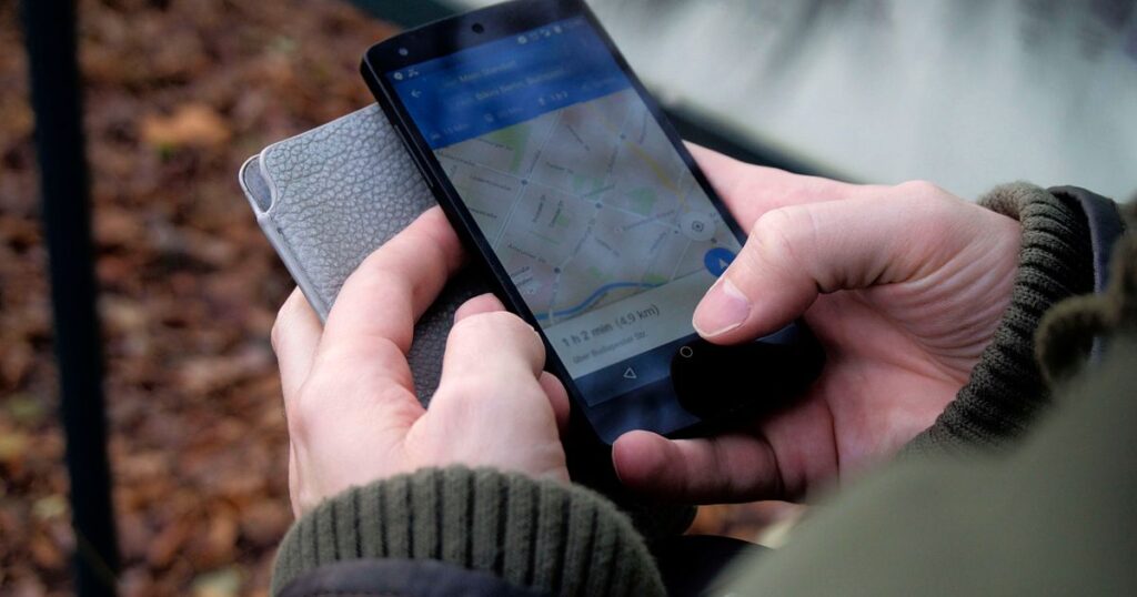 Customer using Google Maps on a smartphone to find a local business