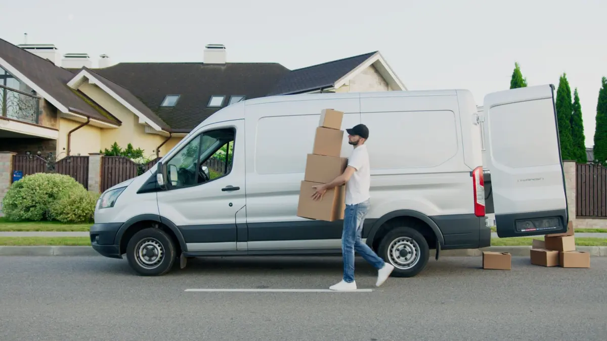 Man unloading boxes from a van, like a service-area business that travels to customers