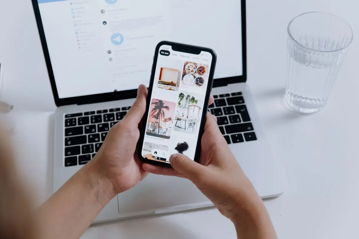 Person checking a website on a smartphone, testing mobile layout and speed before launch