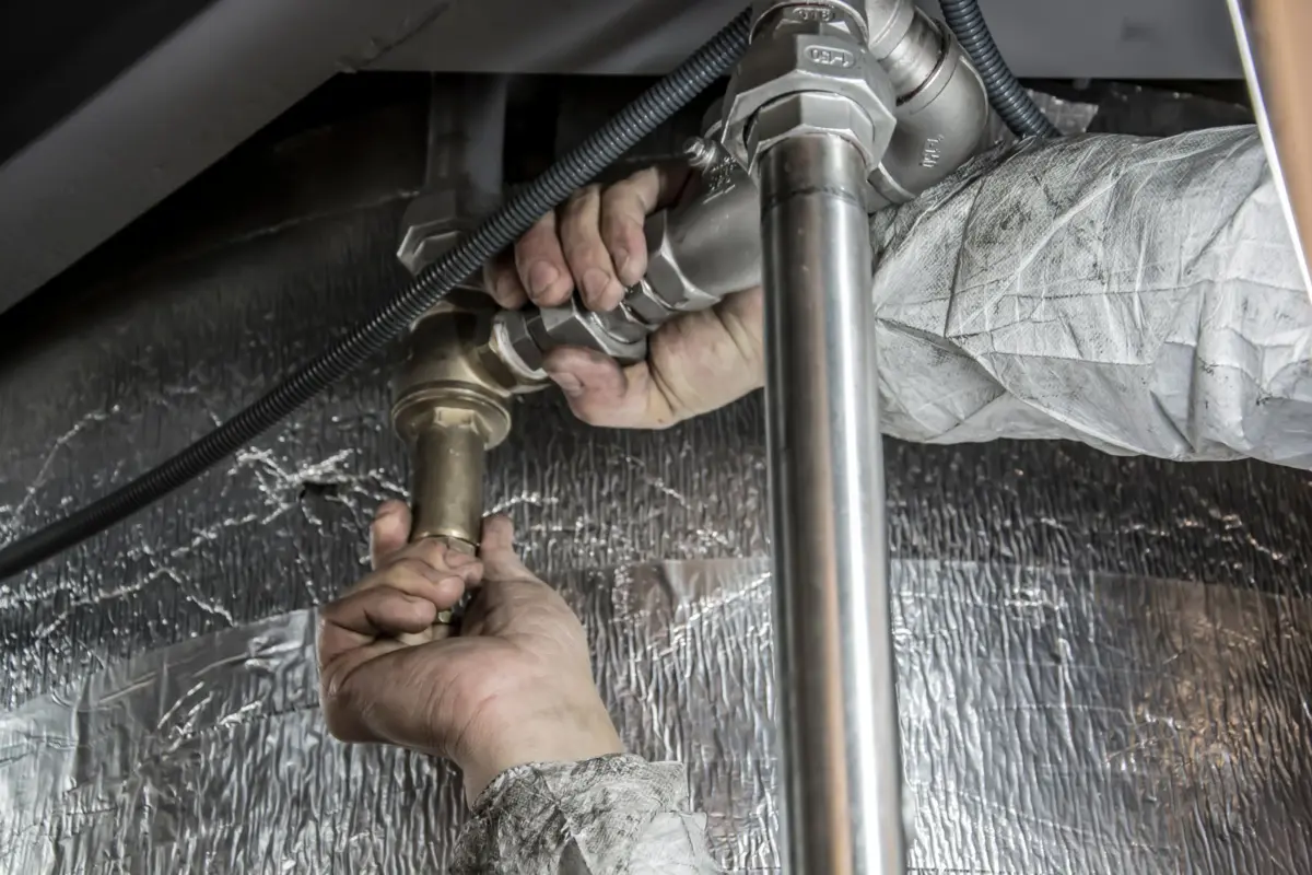 Plumber fitting pipes on a job, a typical service-area business on Google Maps