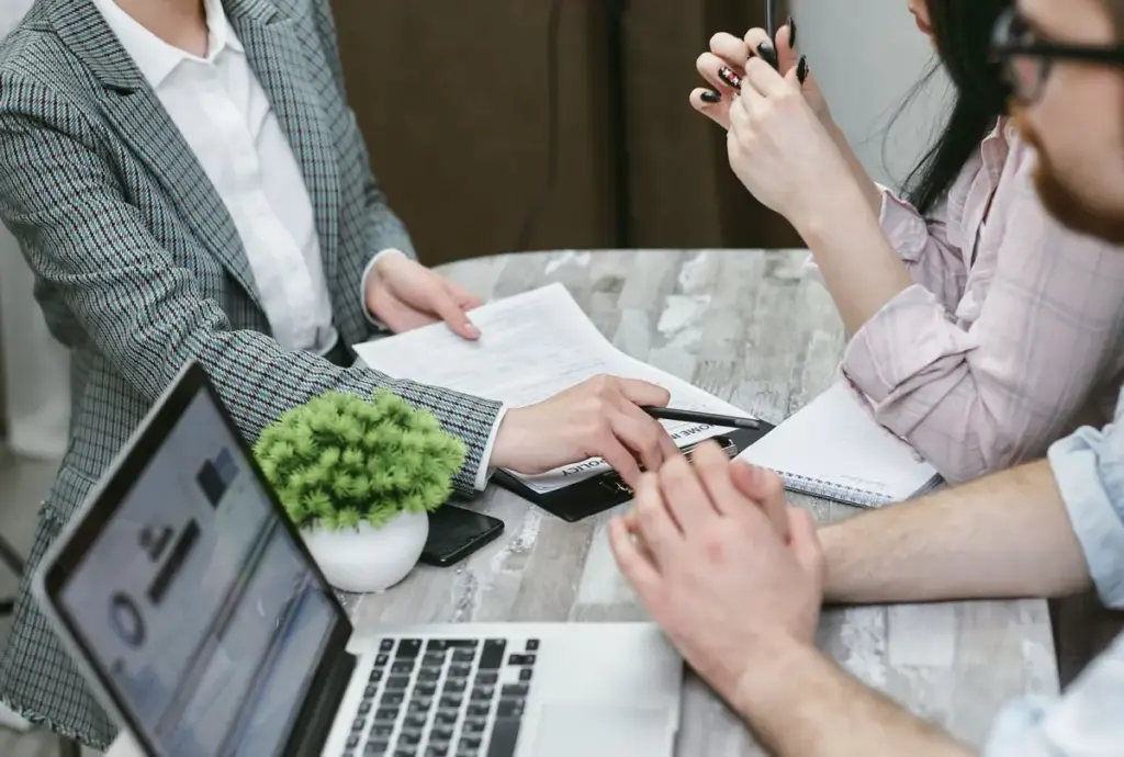Small business owners meeting a web designer with questions to ask a web designer