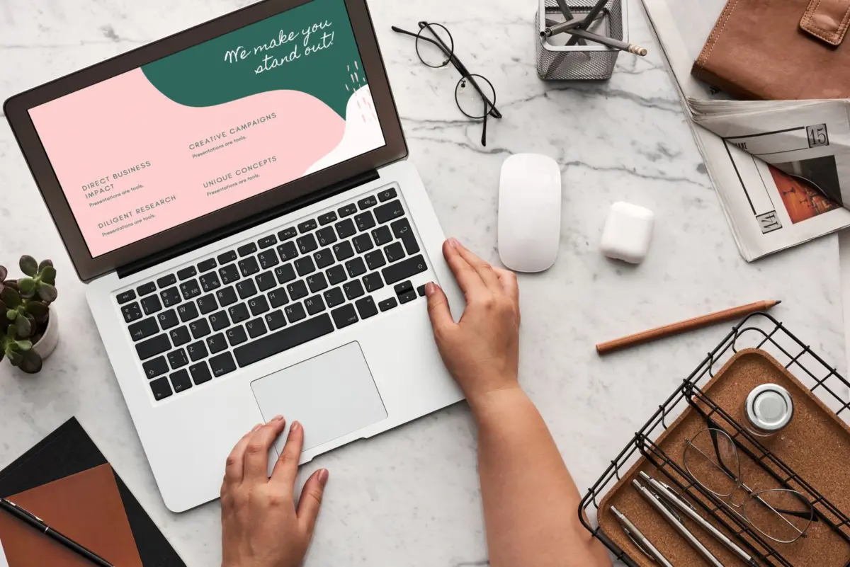Designer reviewing a finished website on a laptop, checking portfolio work before hiring