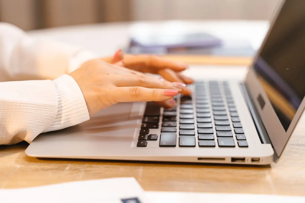Business owner typing on a laptop while replying to customer reviews online
