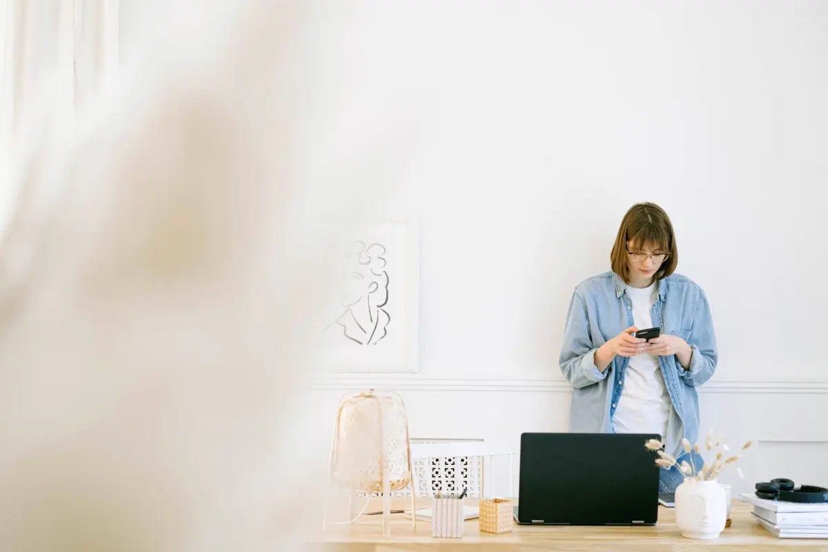Small business owner sending a Google review request by text message on her phone