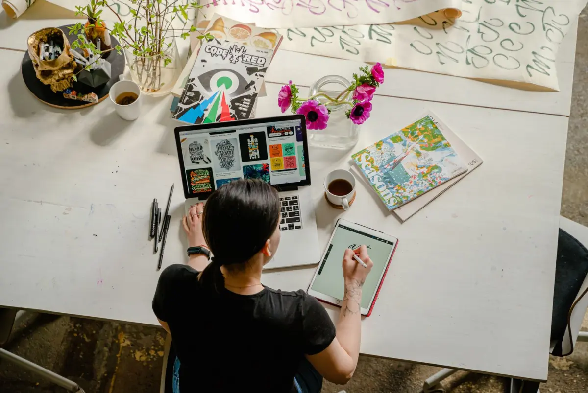 Small business owner working on her website and service pages at a desk