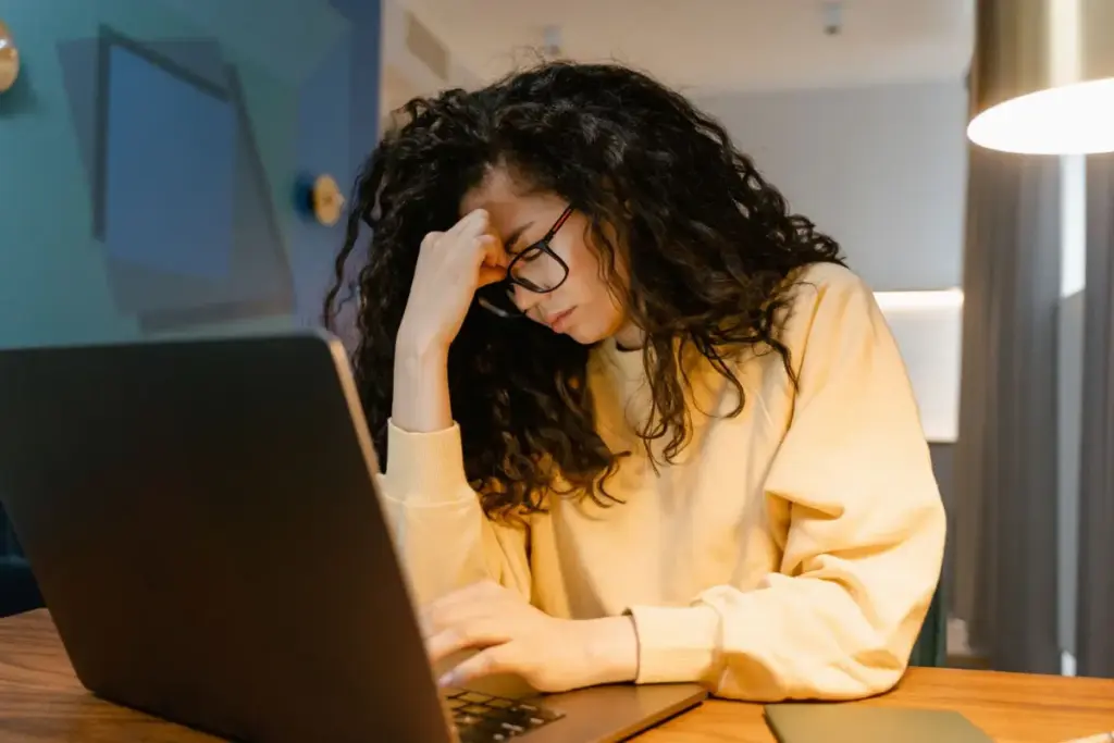 Frustrated business owner at her laptop, worried about her website not showing on Google